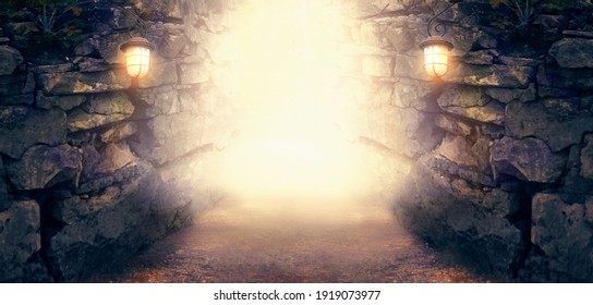 Fantasy stone dungeon cave with glowing lanterns on walls, lamp illuminate magical trail leading out from old ancient cavern towards mystical glow, scene with abandoned ruins, empty road and tunnel. - Powered by Shutterstock