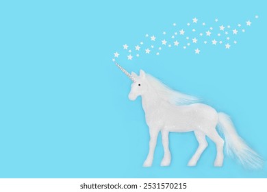 Fantasy unicorn Christmas decoration with white stars background on blue. Magical festive tree bauble  Greeting card, gift tag invitation. Copy space. - Powered by Shutterstock