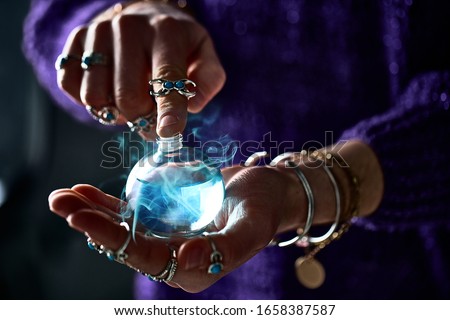 Fantasy witch wizard woman using enchanting magical elixir potion bottle for love spell, witchcraft and divination. Magic illustration and alchemy