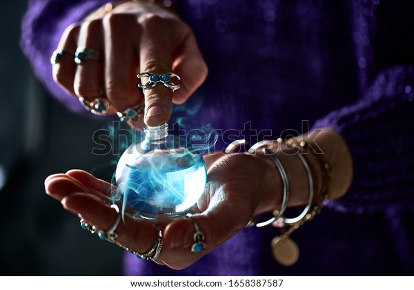 Fantasy witch wizard woman using enchanting\
magical elixir potion bottle for love spell, witchcraft and\
divination. Magic illustration and\
alchemy
