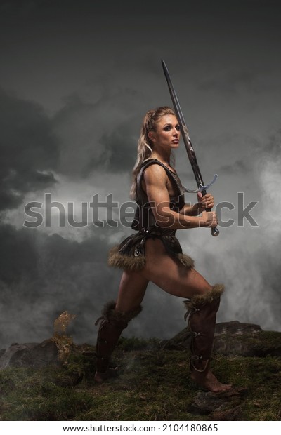 Fantasy woman warrior\
in laether armor stained with blood and mud, holding sword.\
Cosplayer historical\
viking