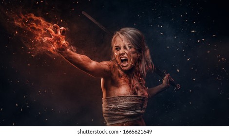 Fantasy woman warrior wearing rag cloth stained with blood and mud in the heat of battle.