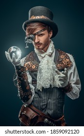 Fantasy World. Portrait Of A Handsome Steampunk Man On A Dark Blue Background.  