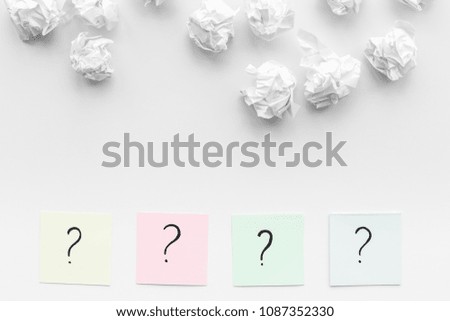 FAQ concept. Question mark on sticky notes near crumpled paper on white background top view copy space