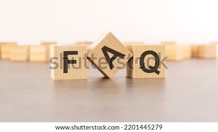 FAQ - Frequency Asked Questions - letter pices on the wooden cubes, white background