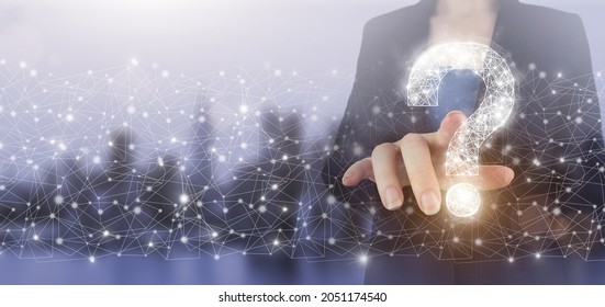 FAQ frequently asked questions concept. Hand touch digital screen hologram question mark sign on city light blurred background. Business support concept. Problems and solutions - Shutterstock ID 2051174540