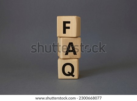 FAQ - Frequently Asked Questions symbol. Concept word FAQ on wooden cubes. Beautiful grey background. Business and FAQ concept. Copy space.