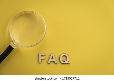 FAQ wood letters searching for facts truth news answers concept copy space flat lay on muted yellow