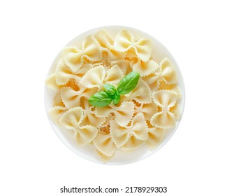 Farfalle, cooked pasta with basil green leaves, on plate, top view, isolated on white background with clipping path.
