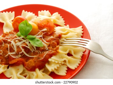 Farfalle on red plate