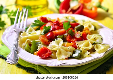 Farfalle with vegetable on a yellow wooden table. - Powered by Shutterstock