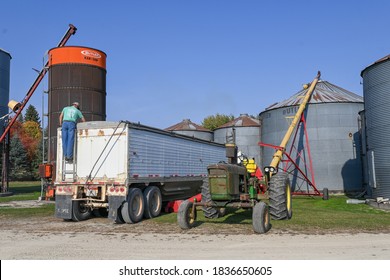 Faribault, MN/USA - October 11, 2020. A Farmer Makes Sure Everything Is Working Well As He Transfers Soybeans From Semi-trailer To Grain Bin During Harvest. 