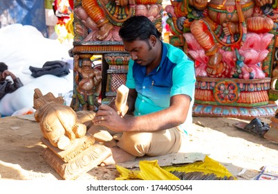 FARIDABAD, HARYANA / INDIA - FEBRUARY 2020 : Men At Work, Indian Male Artist Making Idol Of Indian God With Wood At Surajkund Craft Fair