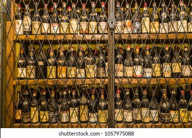 Farigliano, Piedmont, Italy - September 22, 2007: Old bottles in the cellar of a wine producer in Langhe, the largest wine region of Piedmont (UNESCO World Heritage Site).