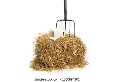 Farm Barn Comfort, A Roll Of Toilet Paper On A Pitch Fork On A Straw Bale Isolated On White