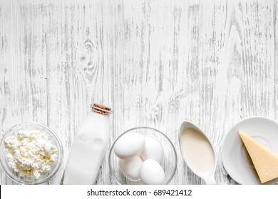 Farm dairy products. Milk, cottage, eggs, cheese on light wooden background top view copyspace - Shutterstock ID 689421412