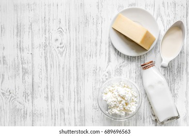 Farm Dairy Products. Milk, Cottage, Cheese, Eggs On Light Wooden Background Top View Copyspace