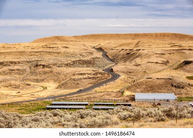 A Farm In Eastern Washington And A Winding And Curvey Road In  High Desert Country