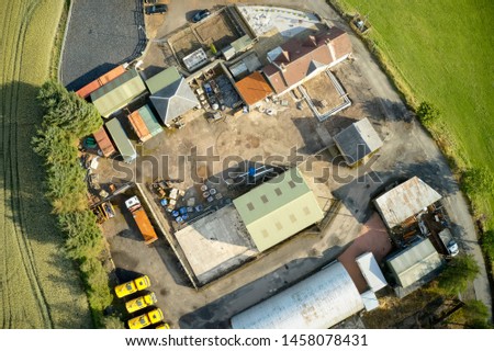 Farm and farmyard buildings in rural countryside aerial view from above
