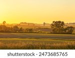 Farm and fields and trees at sunset in northeastern Iowa during the late spring