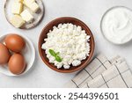 Farm Harvest Dairy products curd cheese, butter, greek yogurt and eggs on grey background, top view. Healthy food