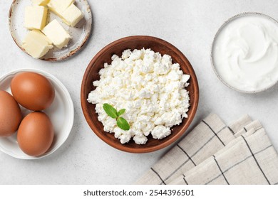 Farm Harvest Dairy products curd cheese, butter, greek yogurt and eggs on grey background, top view. Healthy food