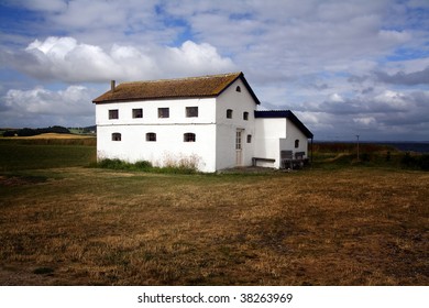 Farm House Isolated In A Field In The Countryside . A Lonely Building In A Meadow In Denmark