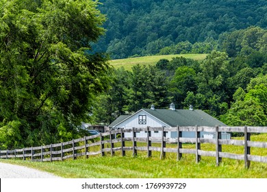 Farm house wooden fence in Roseland, Virginia near Blue Ridge parkway mountains in summer with idyllic rural landscape countryside in Nelson County