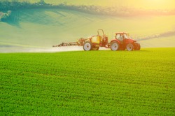 Farm Machinery Spraying Insecticide To The Green Field, Agricultural Natural Seasonal Spring Background