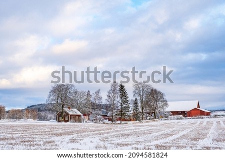 Farm on a field with snow and frost