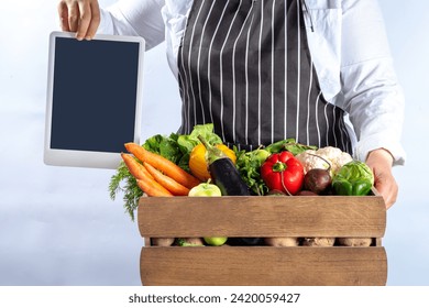 Farm organic market shopping concept, Wooden box with summer, autumn raw vegetables and fruits, in farmer womans hands on white background - Powered by Shutterstock