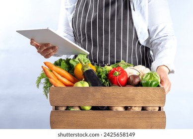 Farm organic market shopping concept, Wooden box with summer, autumn raw vegetables and fruits, in farmer womans hands on white background - Powered by Shutterstock