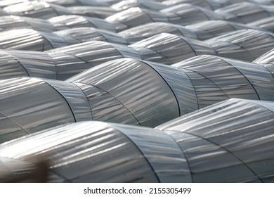 Farm Plantation Covered Under Agricultural Plastic Film Tunnel Rows, Create A Greenhouse Effect, Growing Food, Protecting Plants From Frost And Wind.