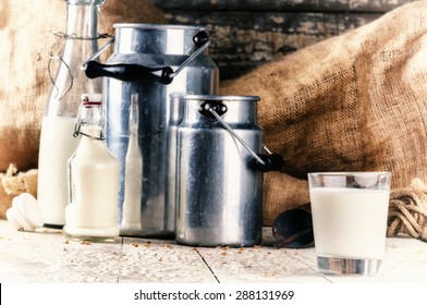 Farm Setting With Fresh Milk In Various Bottles And Cans