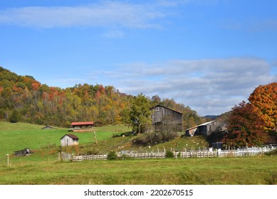 Farm Sits In The Appalachian Foothills Of Tennessee.  Autumn Has Colored Trees.  Rustic Fence Fronts Old Barn.