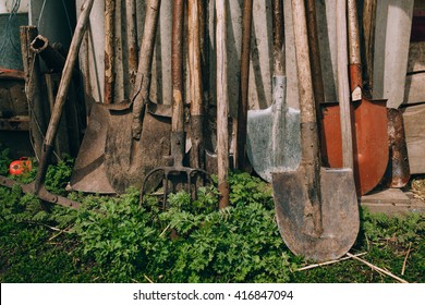 Farm Tools In Front Of A Wooden Old Barn