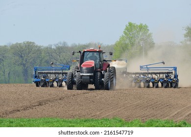 Farm Tractor Pulling A Planter To Seed The Spring Crop In Illinois