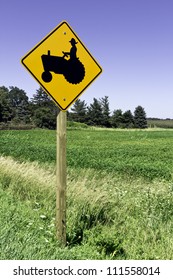 Farm Tractor Road Sign Against Blue Sky