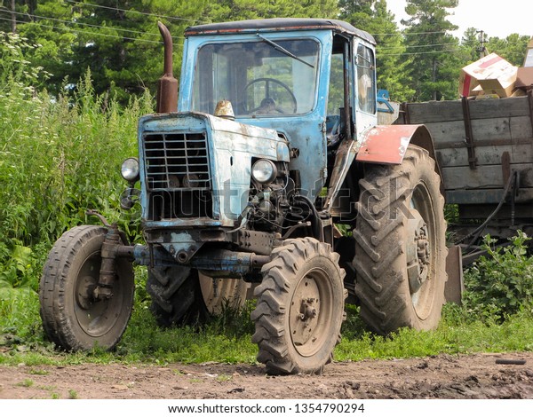 Farm tractor with\
trailer