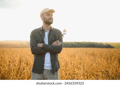 Farmer agronomist on a soybean field. Agricultural industry - Powered by Shutterstock