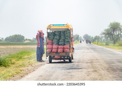 A Farmer Is Carrying Vegetables On A Motor Bike Buggy To The Local Market 