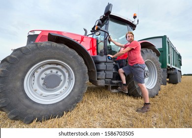 Farmer Climbing Into Cab Of Tractor At Harvest Time