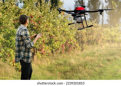 Farmer controls drone sprayer with a tablet. Smart farming and precision agriculture - Shutterstock ID 2239201853
