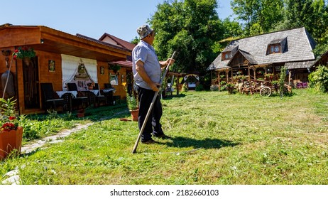 A Farmer Is Cutting Gras With A Sense In Oncesti Romania, July 07, 2022