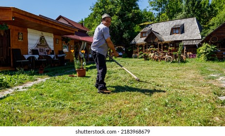 A Farmer Is Cutting Gras With A Sense In Oncesti Romania, July 07, 2022