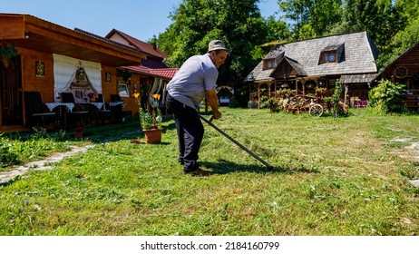 A Farmer Is Cutting Gras With A Sense In Oncesti Romania, July 07, 2022