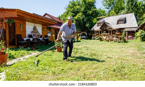 A Farmer Is Cutting Gras With A Sense In Oncesti Romania, July 07, 2022