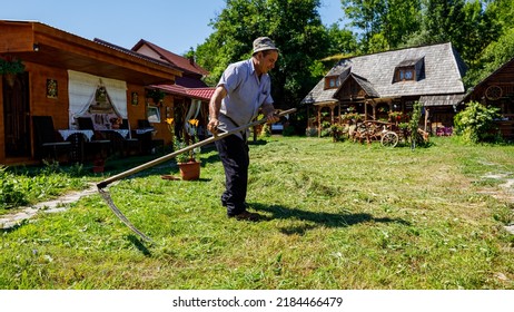 A Farmer Is Cutting Gras With A Sense In Oncesti Romania, July 07, 2022