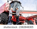 Farmer and dealer shaking hands after successful tractor purchase. Investing in farming equipment.