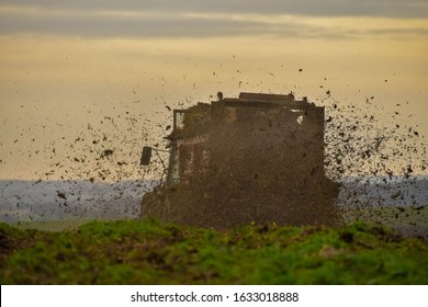 Farmer Dispersing Manure In Fields